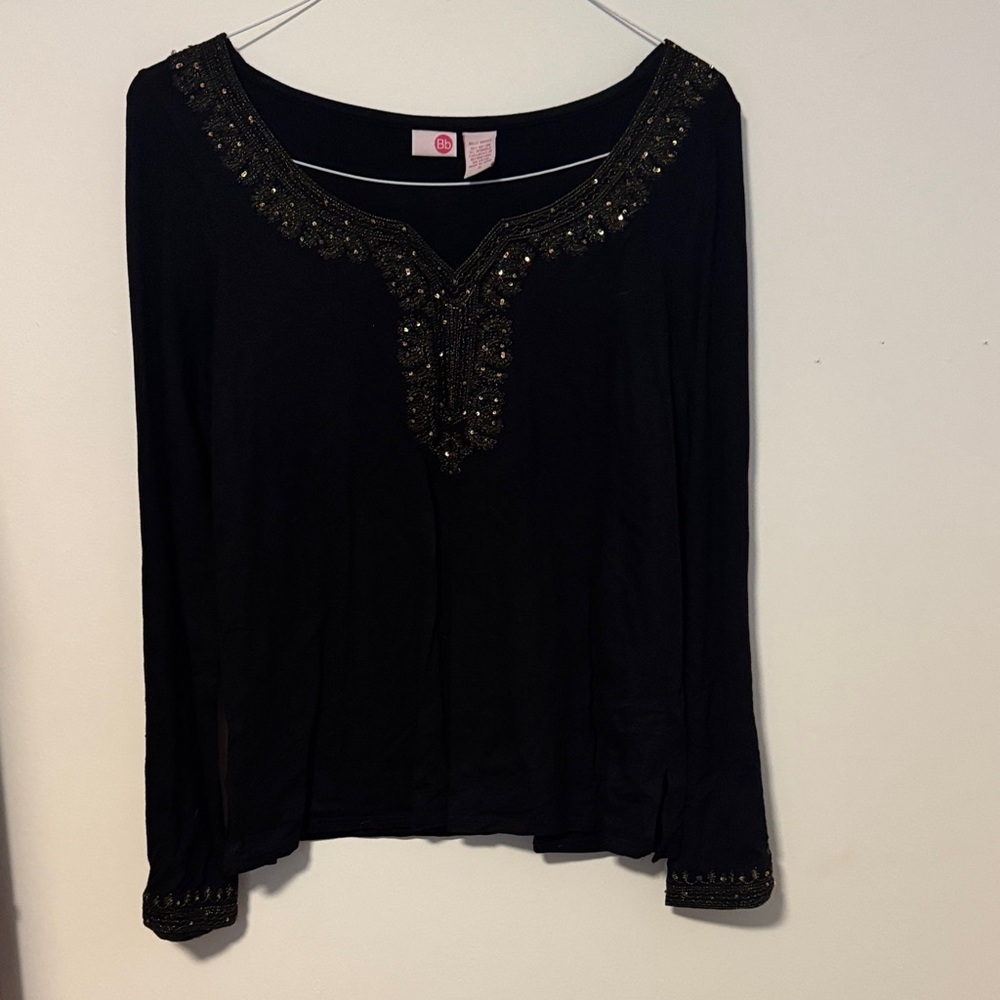Soft stretchy.  Vintagey.   Collar arms and cuffs adorned with sparkles